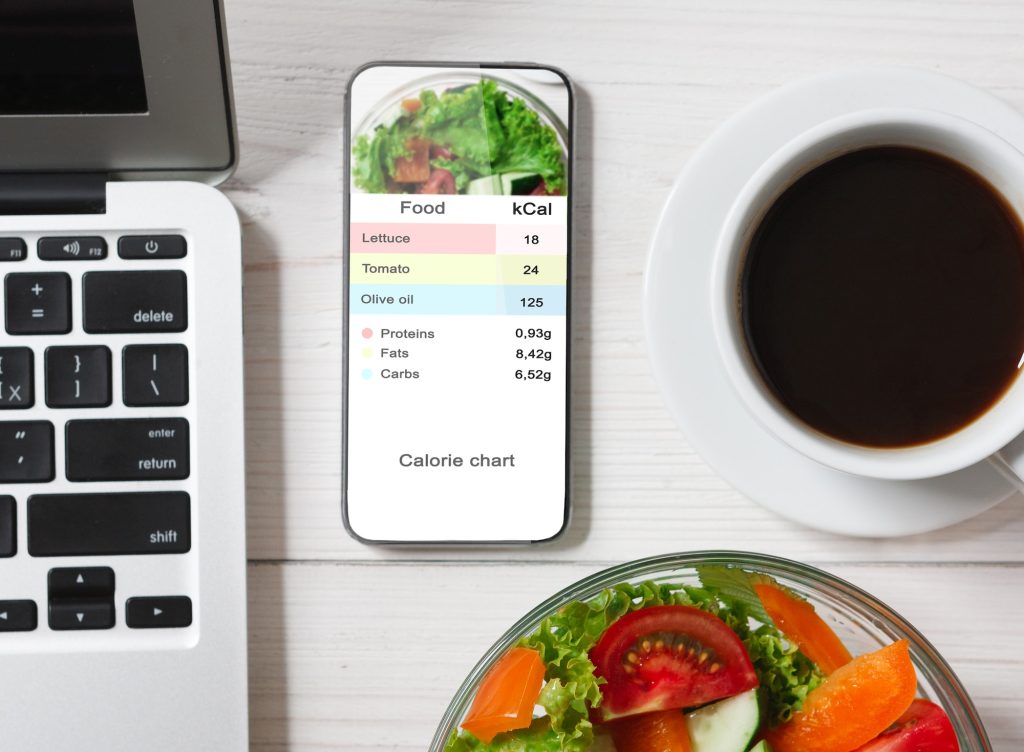 Calorie Counter. Smartphone With Application For Counting Calories Flat Lay On Table